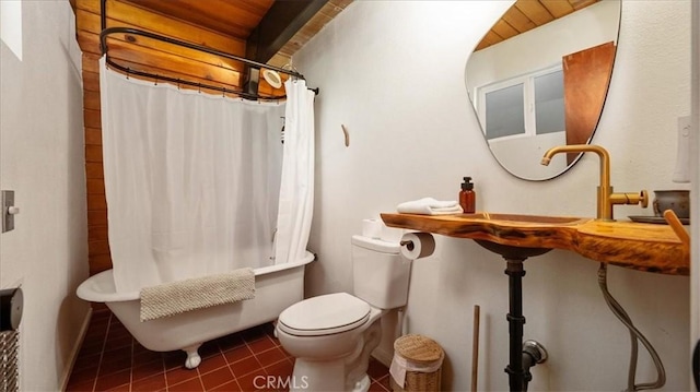 full bath featuring tile patterned floors, shower / bath combo, and toilet