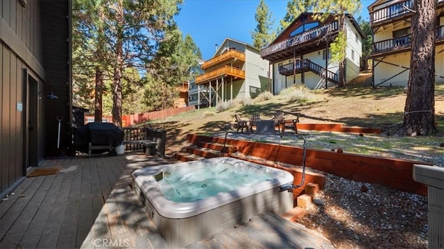 deck featuring grilling area and an outdoor hot tub