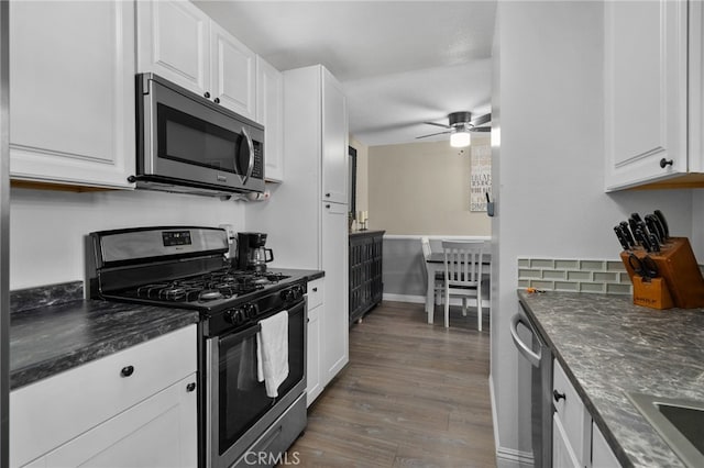 8990 19th St Unit 433, Rancho Cucamonga, CA 91701 - kitchen featuring wood finished floors, baseboards, white cabinets, a ceiling fan, and appliances with stainless steel finishes