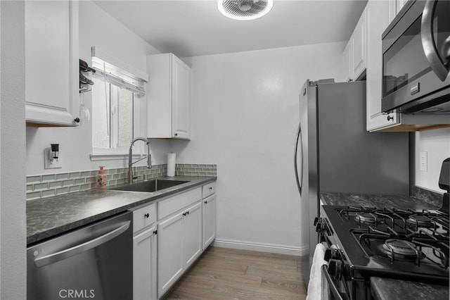 8990 19th St Unit 433, Rancho Cucamonga, CA 91701 - kitchen with dark countertops, a sink, light wood finished floors, dishwasher, and black gas range