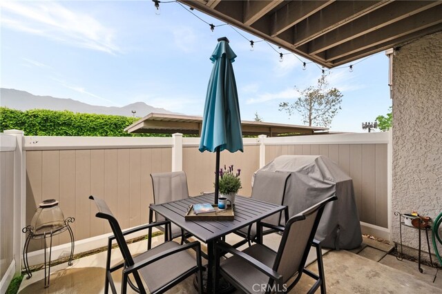 8990 19th St Unit 433, Rancho Cucamonga, CA 91701 - view of patio / terrace featuring outdoor dining area, a fenced backyard, and a mountain view