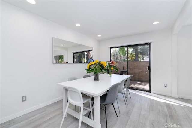 dining area with light wood-style floors, baseboards, and recessed lighting