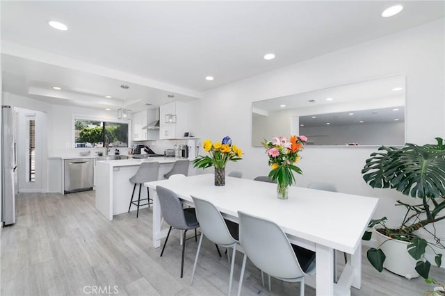 dining area with recessed lighting and light wood finished floors