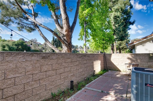 exterior space featuring a fenced backyard and central AC