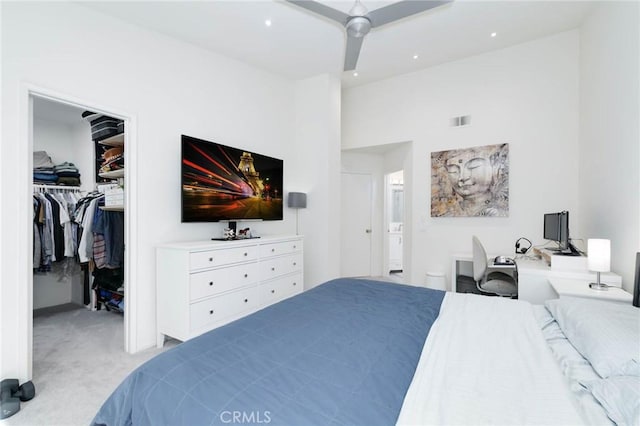 carpeted bedroom featuring visible vents, recessed lighting, a walk in closet, and a closet