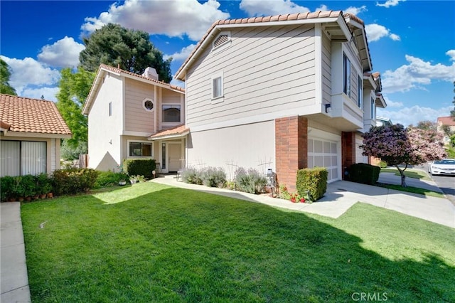 view of front of home with a garage, a tiled roof, a front yard, and concrete driveway