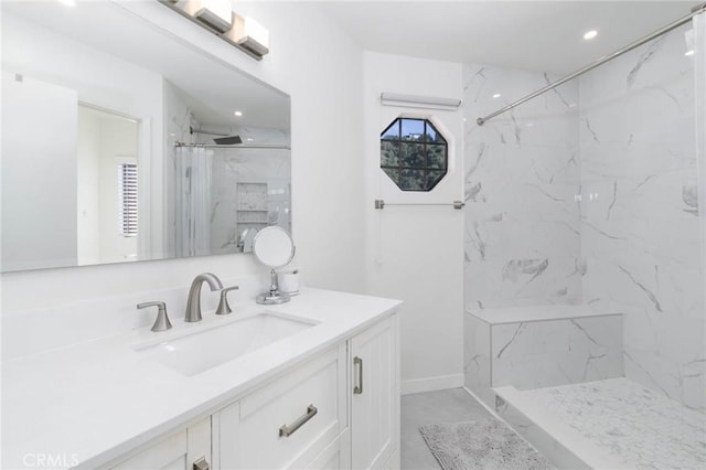 bathroom with vanity, recessed lighting, and a marble finish shower