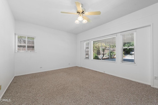 spare room with a ceiling fan, baseboards, and carpet floors