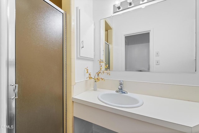 full bathroom with a stall shower and vanity