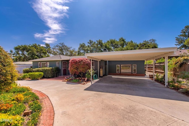 view of front of home featuring driveway and fence