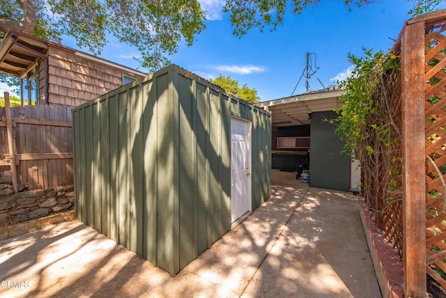 view of shed featuring fence