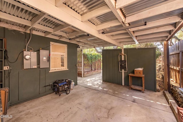 view of patio with fence and electric panel