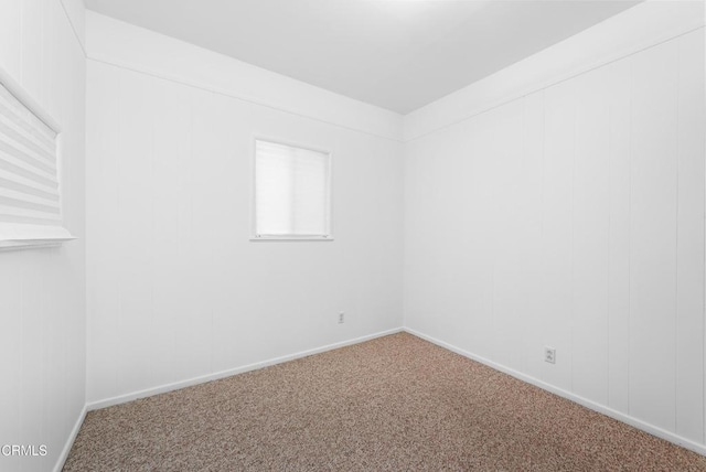 carpeted empty room with baseboards