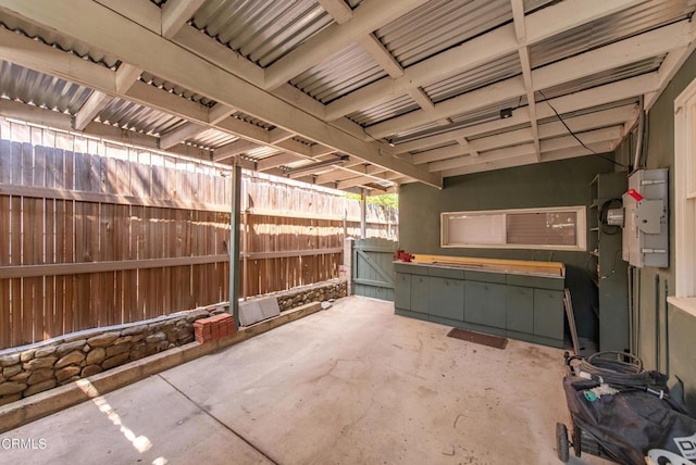 view of patio featuring fence and a gate