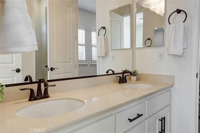 bathroom featuring double vanity and a sink