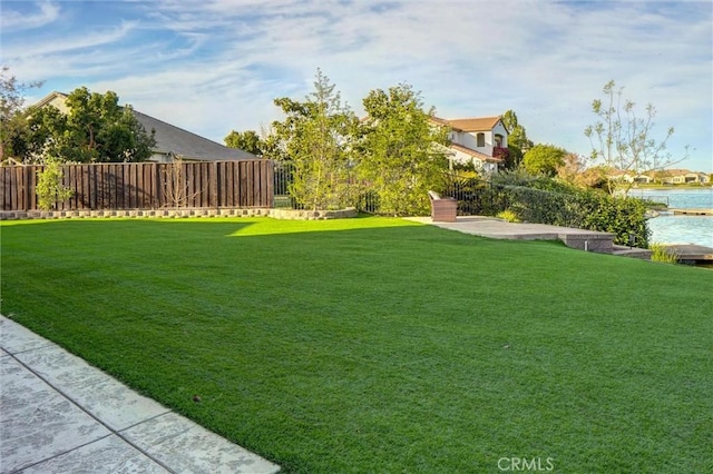 view of yard with fence and a patio
