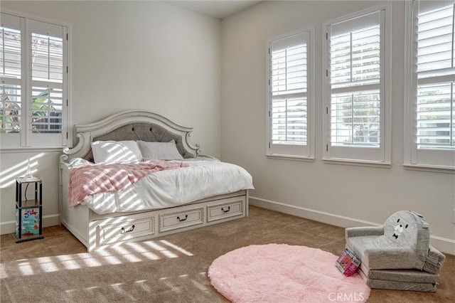 carpeted bedroom featuring baseboards