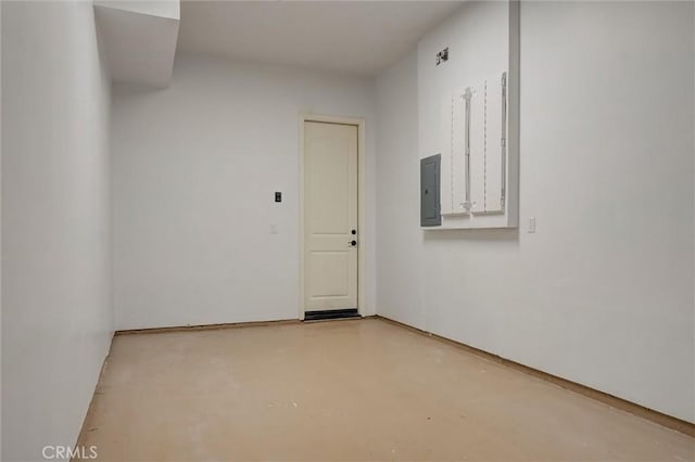 unfurnished room featuring finished concrete flooring and electric panel