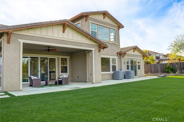back of property featuring a patio, fence, a ceiling fan, and a lawn