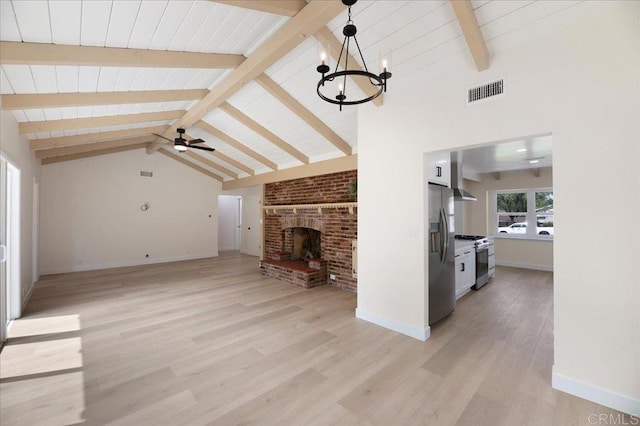 unfurnished living room with a ceiling fan, a chandelier, baseboards, and light wood finished floors