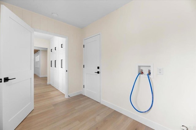 corridor featuring light wood-type flooring and baseboards