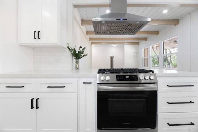 kitchen with stainless steel range with gas cooktop, exhaust hood, light countertops, white cabinetry, and tasteful backsplash