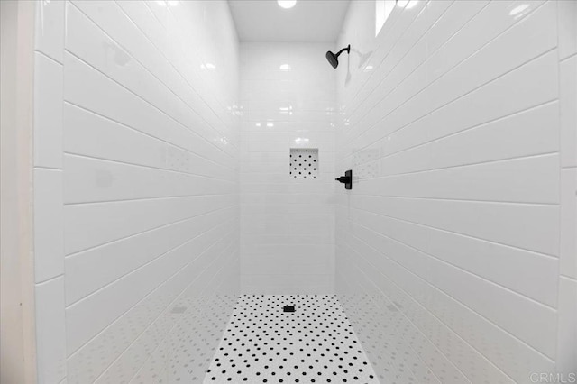 bathroom with a tile shower