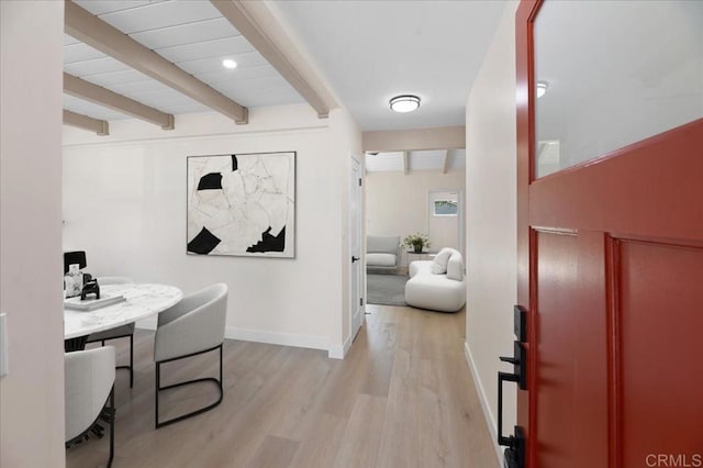 office space with beam ceiling, light wood finished floors, and baseboards