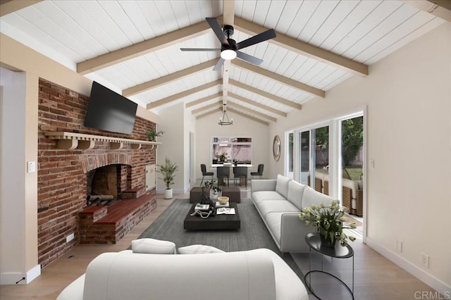 living area featuring ceiling fan, a brick fireplace, baseboards, wood finished floors, and wooden ceiling