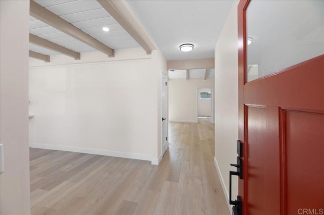 hall featuring beamed ceiling, light wood finished floors, and baseboards