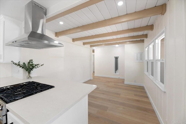 kitchen featuring island range hood, stainless steel range with gas cooktop, light wood-style flooring, light countertops, and recessed lighting