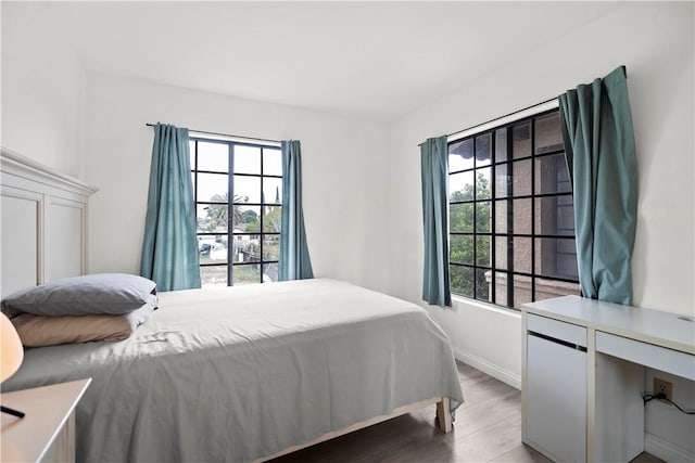1029 S Reservoir St, Pomona, CA 91766 - bedroom featuring baseboards and wood finished floors