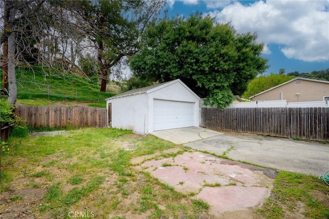 detached garage featuring fence