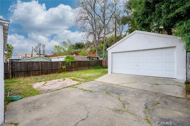 detached garage featuring fence