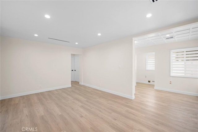 interior space featuring baseboards, recessed lighting, and light wood finished floors