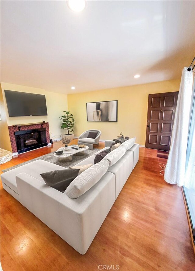 17762 Palo Verde Ave, Cerritos, CA 90703 - living area featuring light wood finished floors, recessed lighting, and a fireplace