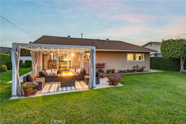 back of property at dusk featuring an outdoor living space with a fire pit, a pergola, stucco siding, a patio area, and a lawn