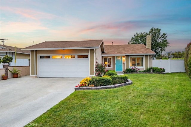 ranch-style home with driveway, a chimney, a garage, fence, and a yard