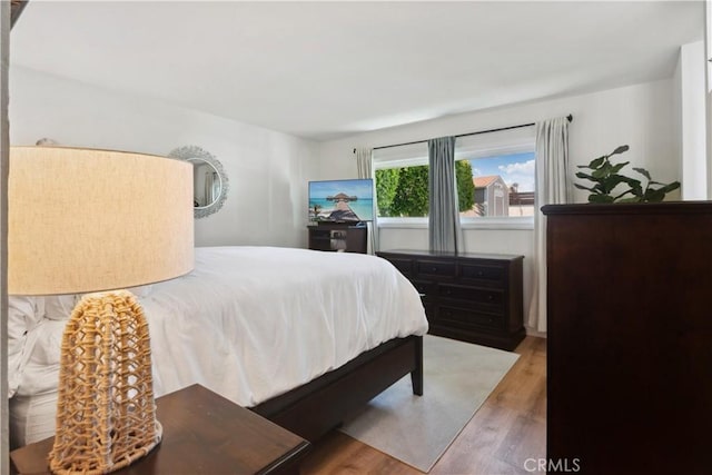 bedroom featuring wood finished floors