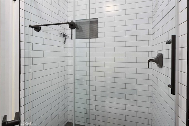 full bath featuring a shower stall