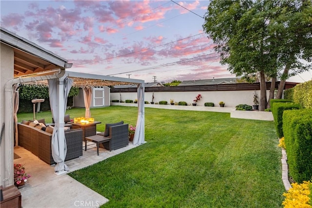 view of yard with a storage unit, a pergola, a patio, a fenced backyard, and an outdoor structure