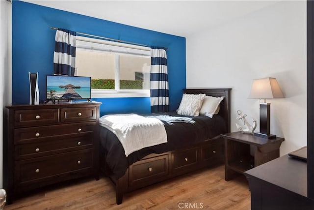 bedroom featuring wood finished floors