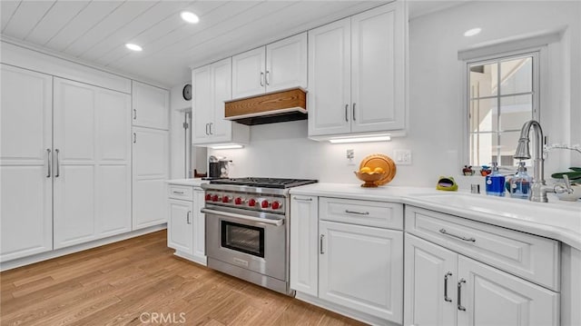 2617 Huntington Ln Unit B, Redondo Beach, CA 90278 - kitchen featuring premium range, under cabinet range hood, recessed lighting, white cabinetry, and light countertops