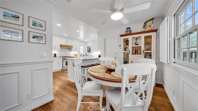 2617 Huntington Ln Unit B, Redondo Beach, CA 90278 - dining area with light wood finished floors, ornamental molding, a decorative wall, a ceiling fan, and wainscoting