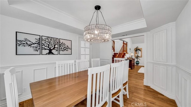 2617 Huntington Ln Unit B, Redondo Beach, CA 90278 - dining space with a raised ceiling, a chandelier, wood finished floors, a decorative wall, and a wainscoted wall