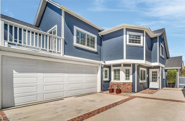 2617 Huntington Ln Unit B, Redondo Beach, CA 90278 - view of front facade with a balcony, driveway, and a garage