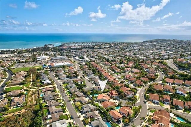 drone / aerial view featuring a residential view and a water view