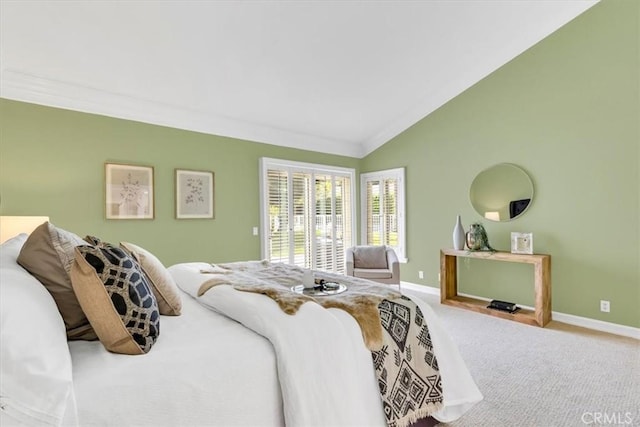 carpeted bedroom with baseboards and vaulted ceiling