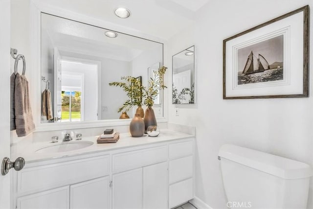 bathroom featuring recessed lighting, vanity, and toilet