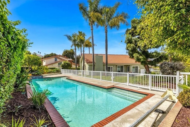 view of pool with a fenced in pool and fence